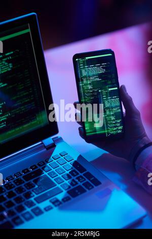 Closeup on modern woman with smartphone developing program. Stock Photo
