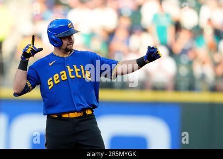 Seattle Mariners' Cal Raleigh reacts after hitting a walk-off single to win  the game 1-0 over the New York Yankees as teammate Julio Rodriguez (44)  runs towards him in a baseball game