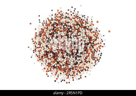 Quinoa seeds pile top view isolated on white. Raw mixed tricolor amarant grain. Gluten-free cereal. Stock Photo