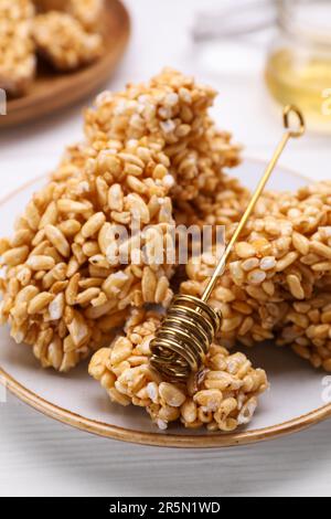 Puffed rice bars (kozinaki) on white plate, closeup Stock Photo