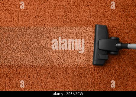 Vacuuming carpet. Clean area after using device, top view Stock Photo