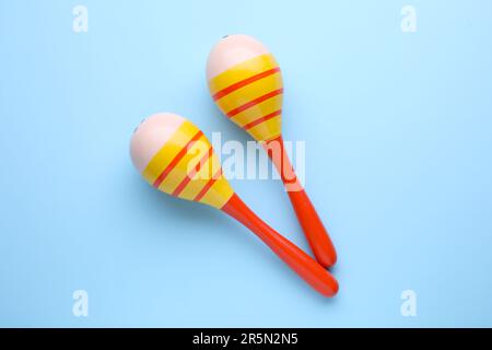Colorful maracas on light blue background, flat lay. Musical instrument Stock Photo