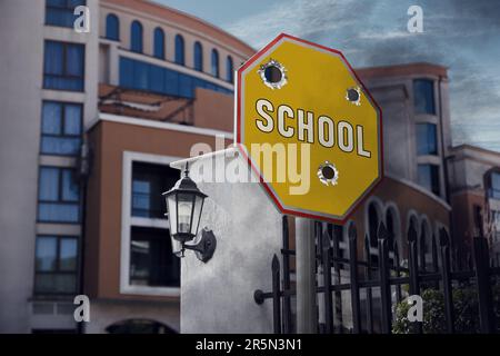 School sign damaged with shooting near building Stock Photo