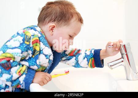 Dental care, small boy washing his teeth Stock Photo