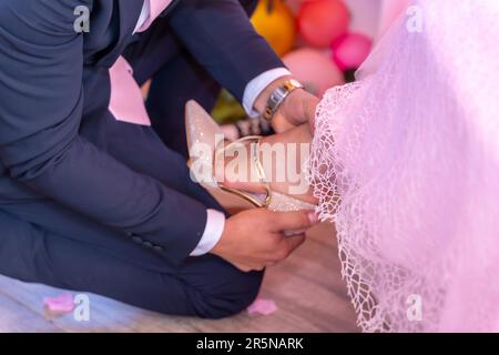 Father putting the shoes on his daughter on her 15th birthday, traditional Latin American and Spanish party Stock Photo