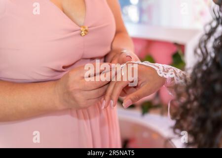 Mother placing a ring on her daughter on her 15th birthday, traditional Latin American and Spanish party Stock Photo