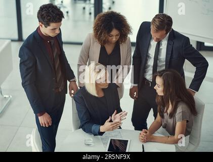 Theyve mastered the art of productive meetings. a group of colleagues collaborating on a project in a modern office. Stock Photo