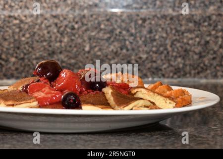 Close up of pancakes with fruit on top. Stock Photo