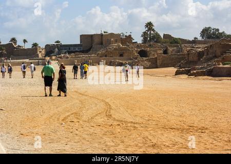 Tourists walk the interior of the ancient Roman Hippodrome ruins in Caesarea National Park at Caesarea Maritima, Israel. Stock Photo