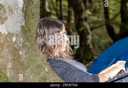 Serene Brunette Woman Finding Peace and Adventure in the Tranquil Forest Stock Photo