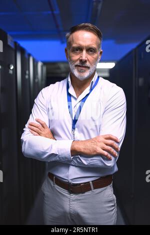 Once I diagnose a problem, I have to fix it. Portrait of a mature man working in a server room. Stock Photo