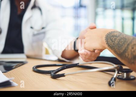 The patient is depending on our cooperation. Closeup shot of doctors shaking hands during a meeting in a hospital. Stock Photo