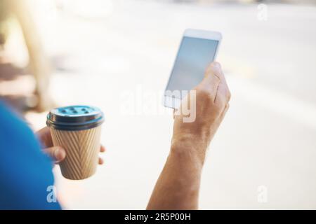 Getting location-based information is so easy online. an unrecognizable man using his cellphone while out in the city. Stock Photo
