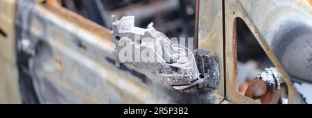 Burnt-out rusty cars on city street, vandalism Stock Photo