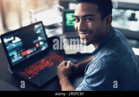 Portrait, man and smile of programmer on computer in office workplace at night. IT, face and male coder or person programming, coding and writing for Stock Photo