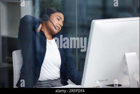 Call center, customer service and woman with back pain in the office while working on an online consult. Medical emergency, sprain neck muscle and Stock Photo