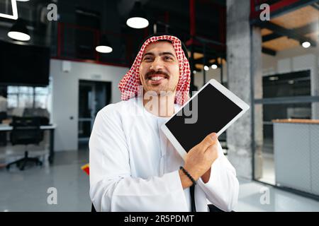 Arab muslim businessman using digital tablet in modern office Stock Photo