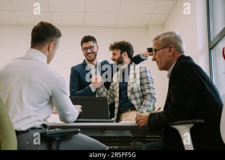 Two young business colleagues agreeing and having a handshake to seal the deal in the office Stock Photo