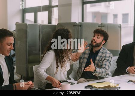 Close up of business man trying to calm his colleague at the business meeting at the co working space Stock Photo
