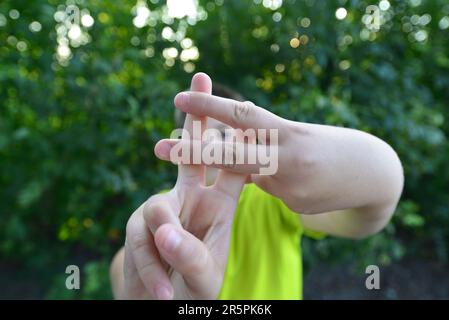 A Boy shows sign gesture prison bars Stock Photo