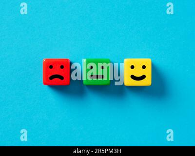 Customer satisfaction, user rating and service evaluation concept. Happy sad and neutral emoticon faces on colorful cubes. Stock Photo