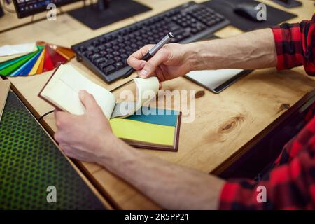 Top view image of graphic designer working with graphic tablet, using color palette, making sketches on computer Stock Photo