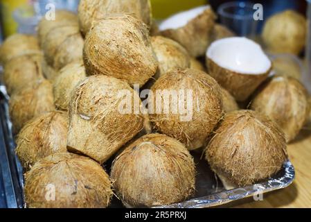 Halved and whole young coconuts for preparation of ice cream in vietnam Stock Photo