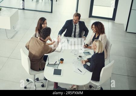 Successful negotiations based on mutual business. two businessmen shaking hands during a meeting in a modern office. Stock Photo