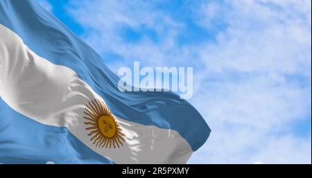 Argentina national flag fluttering in the wind on a sunny day. Three equal blue and white horizontal bands with the Sun of May in the center. 3d illus Stock Photo
