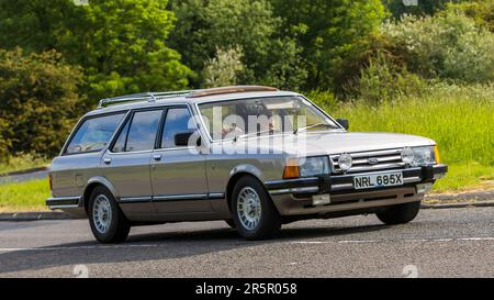 Stony Stratford,UK - June 4th 2023: 1982 beige FORD GRANADA GHIA AUTO classic car travelling on an English country road. Stock Photo