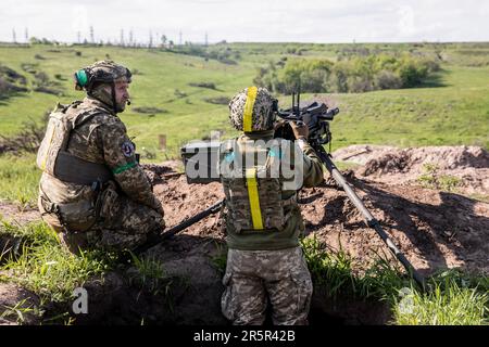 Ukrainian Armed Forces soldiers at a firing position prepare to fire ...