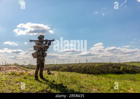 A Ukrainian Armed Forces soldier with a grenade launcher at a firing ...