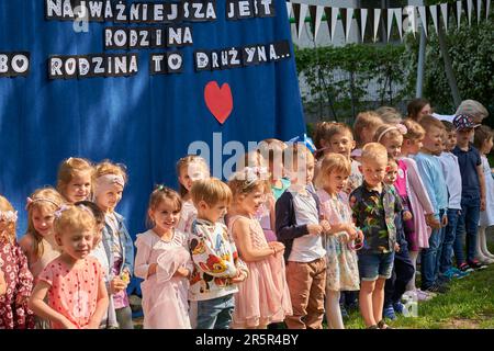 A group of diverse children standing in the park, smiling and enjoying the outdoors Stock Photo
