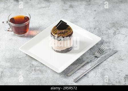 Chocolate single mini cake on a white porcelain plate Stock Photo