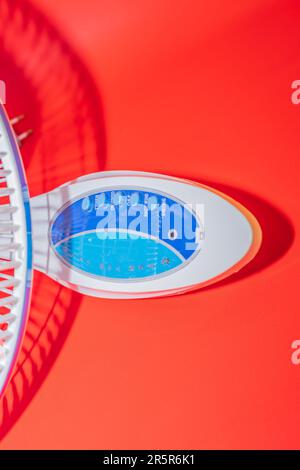 The Blue and White Wall-Mounted Fan is a versatile and practical solution for your cooling needs. Stock Photo