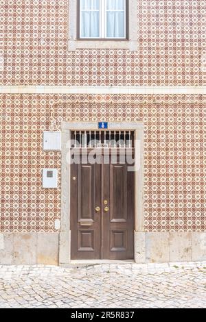 The brown door nr. 4 in Ericeira, Portugal. Summer street and travel photography Stock Photo