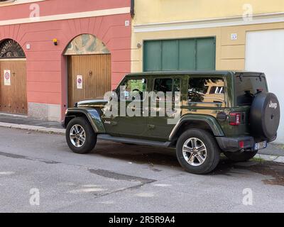 Cremona, Italy - May 2023 Sarge green Jeep Rubicon 4x4 offroad parked in the street. Stock Photo