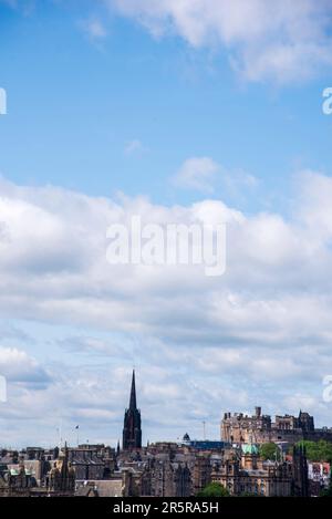 View of Edinburgh Castle and church spires silhouetted against dramatic blue sky Stock Photo