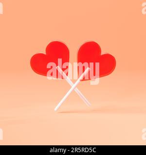 Two red lollipops in heart shapes on sticks, one of them featuring a white background Stock Photo