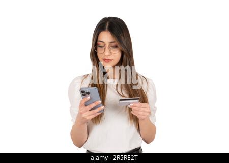Businesswoman online payment concept. Holding debit credit card and smartphone. Using digital shopping application. Using mobile phone. Stock Photo