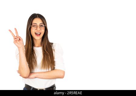 Gesturing v-sign with two fingers, portrait of beautiful happy girl gesturing v-sign with two fingers. Wink one eye, looking camera, ad concept. Stock Photo