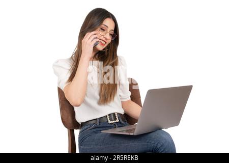 Talking on the phone, side view portrait of modern businesswoman talking on the phone. Smiling happy office worker female sitting on the chair. Stock Photo