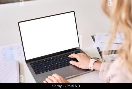 Business woman working on laptop using computer mock up screen. Over shoulder Stock Photo