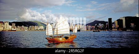 China. Hong Kong. Harbour view by day. Traditional Chinese Junk sailboat in Causeway Bay. Stock Photo