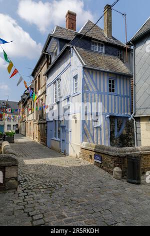 France, Eure, Risle Valley, Pont-Audemer, labeled the Most Beautiful Detours of France, nicknamed the Little Venice of Normandy, Rue Place de la Ville, medieval facade with blue half-timbering in a pedestrian street, small bridge spanning the Risle canal, named Ruisseau des Pâtissiers Stock Photo