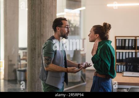 Colleagues arguing in office, problems at work. Stock Photo