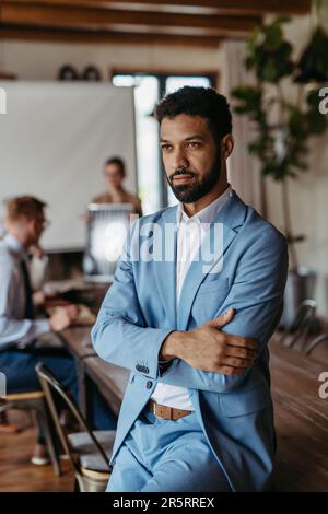 Portrait of confident young businessman during team meeting. Stock Photo