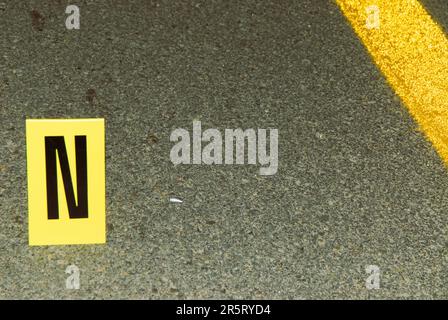 Cartridge case in the middle of the road near evidence stand N Stock Photo