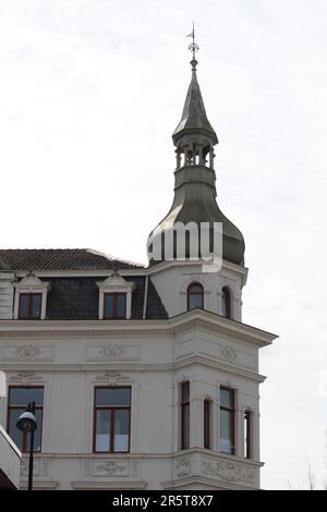 A grand, stately building with an ornate, domed roof stands tall against a brilliant, clear sky Stock Photo