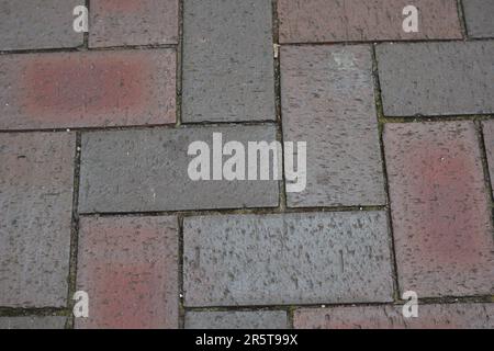 Close-up of a red brick sidewalk with a textured surface Stock Photo